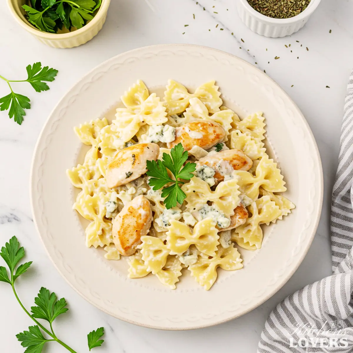 A 90-degree flatlay photo of creamy Chicken Gorgonzola Pasta garnished with fresh parsley.